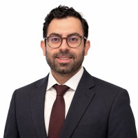 Reza Arabpour wearing a dark suit and tie